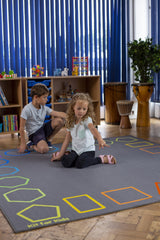Essentials™ Rainbow Geometric Border Carpet